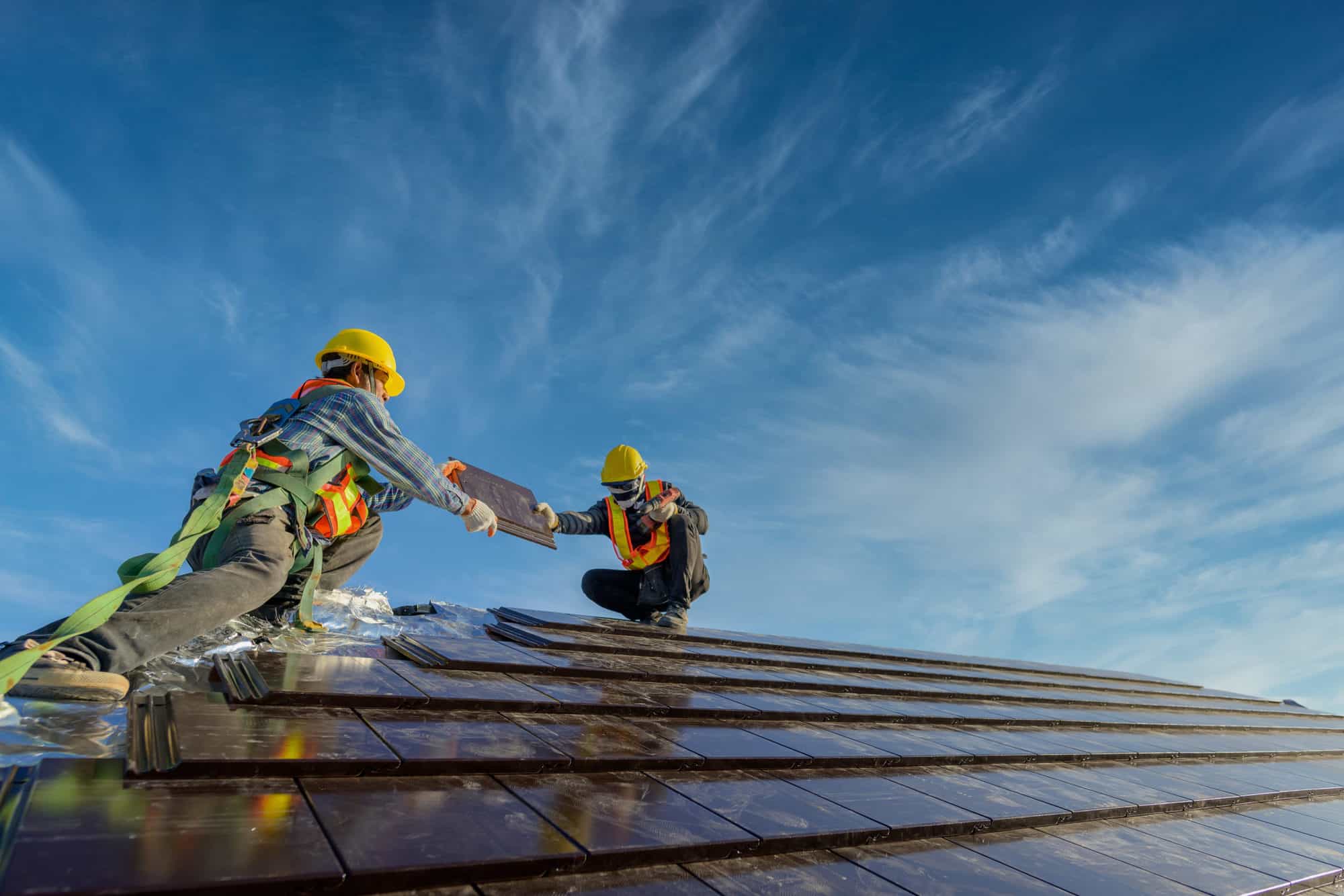 Image displaying two roofers carrying out roof maintenance work